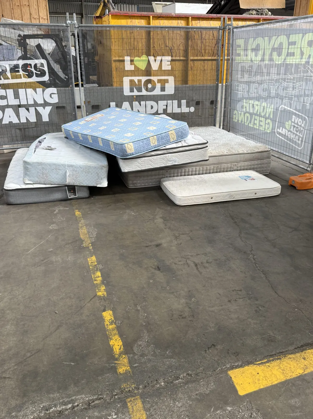 Mattresses stacked at the mattress recycling area